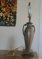 Photo of the Tiffany style lamp base showing dark bronze hue, urn shape, and electric cord