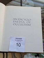 Title page of the book showing 'AN ENCYCLOPAEDIA OF OCCULTISM' with seller number label