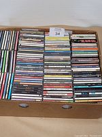 Full box view showing multiple rows of CD cases packed tightly together showing a variety of titles.