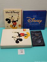 Set of three Walt Disney books and a 4-CD Disney music collection placed on a table, showing front covers including 'The Art of Walt Disney' and 'The Disney Treasures'