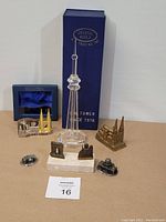 Full view of the miniature buildings including the crystal CN Tower with box, several metal buildings representing different famous landmarks.