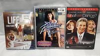 Three DVDs shown side by side Life, Flashdance, Shall We Dance with their front covers visible.