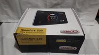 Box of Lennox iComfort S30 Ultra Smart Thermostat showing product image and branding.