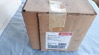 Photo of unopened cardboard box with Honeywell branding and product label showing part number V4055A 1031