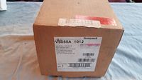 Photo of sealed box labeled Honeywell V5055A 1012 with shipping and product labels visible.