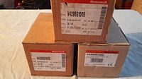 Three Honeywell solenoid gas valve boxes stacked, showing model V4295S1005 labels and electrical specs.