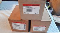 Three cardboard packaged Honeywell gas valves with visible labels showing model V4295S1005.
