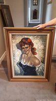 Full view of the vintage painting showing the woman in the gold frame.