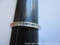 Front profile of ring on mandrel showing channel set diamonds