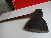 Full length photo of the hand forged battle axe showing twisted oak handle and steel axe head.