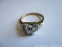 Front three-quarter view showing central and side diamonds