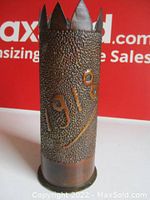 Front view showing the hand punched '1918' date and texturing on thick copper artillery shell.