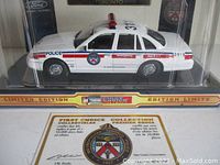 Front and side view of white diecast Toronto Police cruiser model inside original clear display box labeled First Choice Collection Limited Edition. Collector's card visible at front bottom.