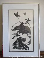 Framed etching showing mother, baby, igloos, and birds in black and white.