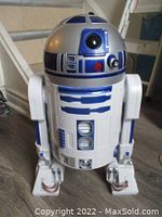Front three-quarter view of the full R2-D2 figure on floor showing dome, body and legs.