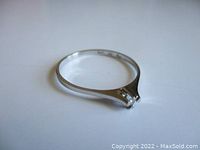 Side angle view of ring, shows band taper and profile of setting