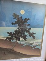 Close-up detail of woodblock print showing tree, moon, and sea waves with layered paint textures.