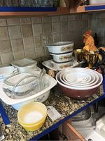 Overview of countertop showing CorningWare dishes, Pyrex bowls, stemware and rooster