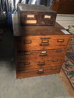 Overall view of both cabinets stacked (small dark unit atop larger oak unit)