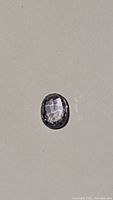 Close-up image of oval cut blueish purple sapphire, showing high luster and clarity.