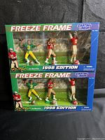 Front view of two boxed 1998 Joe Montana Freeze Frame Starting Lineup action figure sets stacked showing figures and packaging condition.