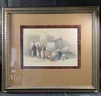 Full view of framed print showing the ornate frame, beige mat, and artwork depicting the temple entrance with figures.