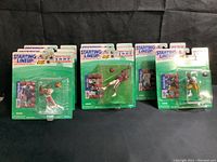 Front view showing six Starting Lineup NFL action figures in original blister packs, 1997 edition with trading cards: Jerry Rice (x2), Michael Westbrook (x3), Jerome Bettis, Steve Young.