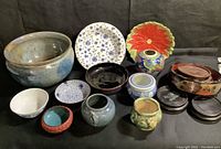 Overview of entire ceramic collection showing various plates, pots, bowls, and vases arranged together.