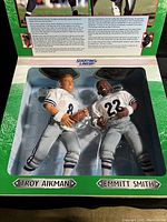 Boxed 1997 Starting Lineup Troy Aikman and Emmitt Smith action figures with clear plastic window, showing figures in football poses inside original carton with backstory and stats.