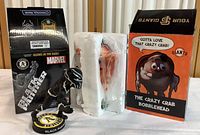 Oakland Athletics Black Panther glow-in-the-dark figure displayed next to sealed San Francisco Giants Crazy Crab bobblehead box wrapped in packing material.