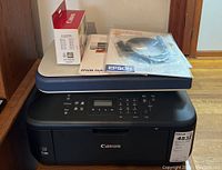 Canon Pixma printer with Epson Perfection 1250 scanner and accessories arranged on top