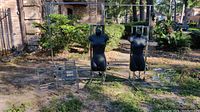 Wide shot showing outdoor setup with display racks, mannequins, and frames.
