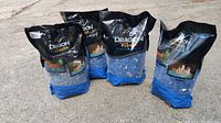 Four full bags of Dragon Glass Cobalt Blue Reflective fire pit crystals, each weighing 10 lbs.
