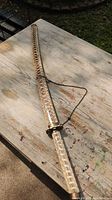 Samurai sword laid on table inside sheath covered with snake pattern leather.