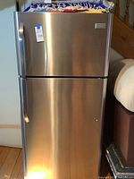 Front view of stainless steel Frigidaire refrigerator/freezer showing curved handles