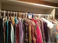 Overview of rack with multiple women's hanging tops
