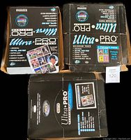 Three boxes of new card collector pages showing Ultra Pro Platinum branding and labels indicating pocket configurations (4-pocket, 6-pocket) and Enor 9-card pages.