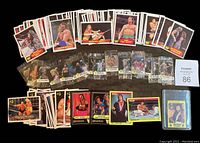 Overview of loose WWF trading cards from 1985 OPC and 1990 Titan sets along with sealed sticker packs