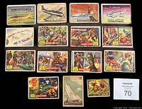 Lot of 14 non-sport trading cards from the 1950s displayed together showing various themes such as aviation, wildlife, and military.
