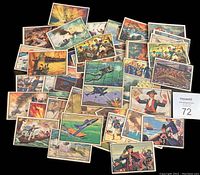 Spread of 44 colorful 1954 Bowman U.S. Navy Victories trading cards showing fronts with various naval battle scenes, planes, and sailors.