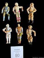 Photo of all six G.I. Joe figures arranged in two rows showing various uniform colors and articulation details.