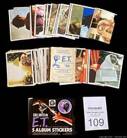Complete set of 120 ET stickers laid out showing various movie scenes and characters.