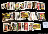 Full lot of 64 Wacky Packages stickers arranged on a flat surface showing variety and quantity