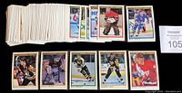 Stack of 1990-91 OPC Premier hockey cards spread on a table showing various player cards at top