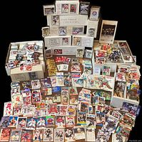 Multiple stacks of white storage boxes and loose cards spread on black background