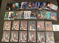 Full view of a large collection displaying various basketball cards spread out on a surface including multiple Michael Jordan cards with action shots, inserts, and holographic cards.