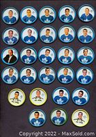 Assorted Toronto Maple Leafs coin buttons with blue rims and player portraits, plus yellow and green All-Star trophy coins