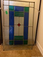Frontal view of stained glass panel showing its color composition and design