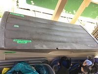 Side and top angled view of the full bin showing the hinged lid and overall structure with some toys inside (not included).