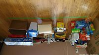 Photo showing the lot's assortment of cleaning supplies including detergent bottles, mop heads, mop pails, paper towels, and cleaning accessories arranged on the floor.